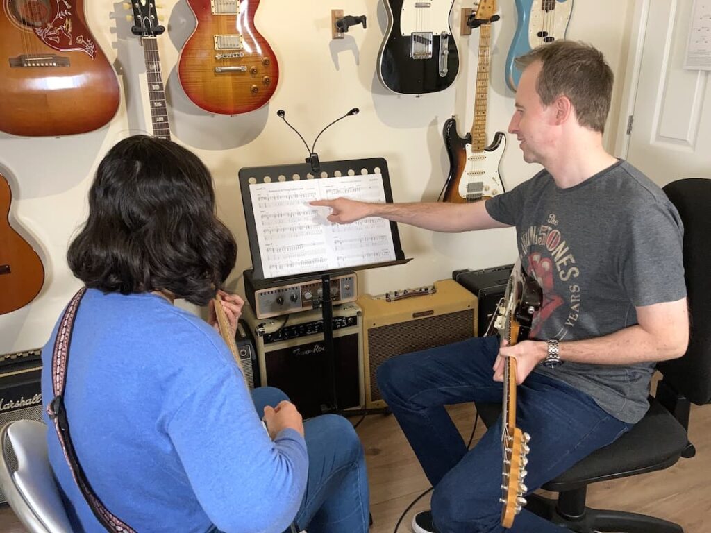 Photo of guitar lesson with woman